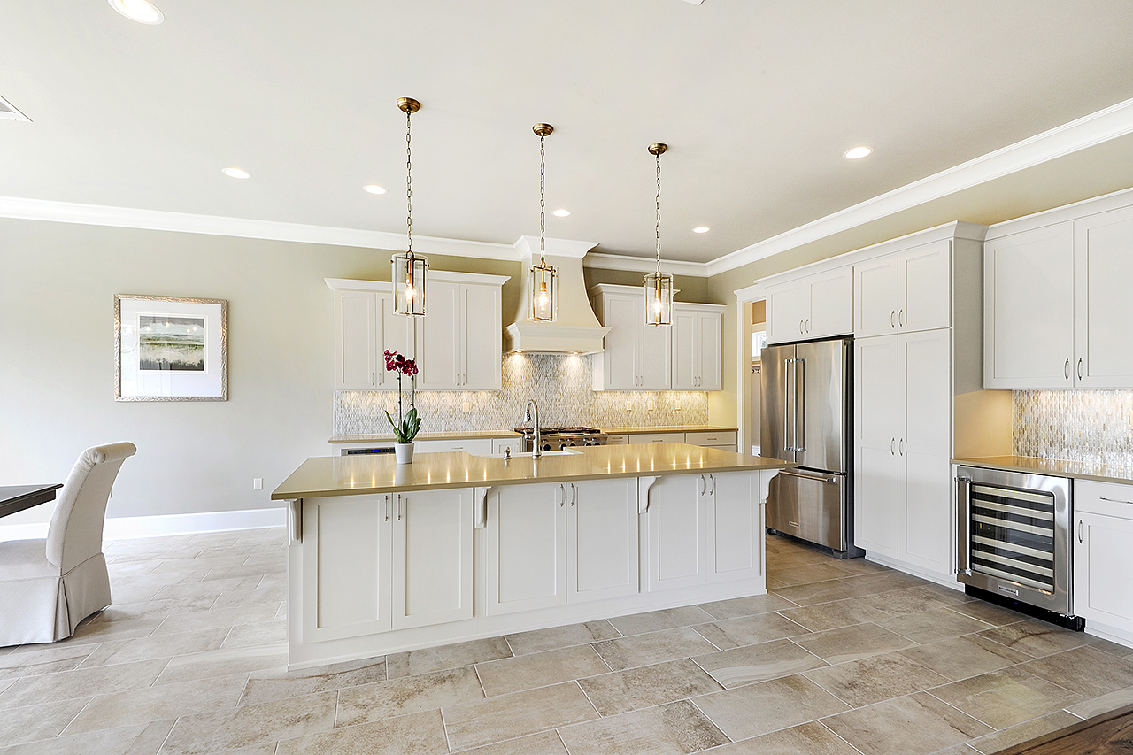 kitchen with counter island, refrigerator, pendant lights