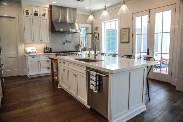 kitchen island, cabinets, sink, lighting, range hood, countertops | Stone Creations, Covington, LA